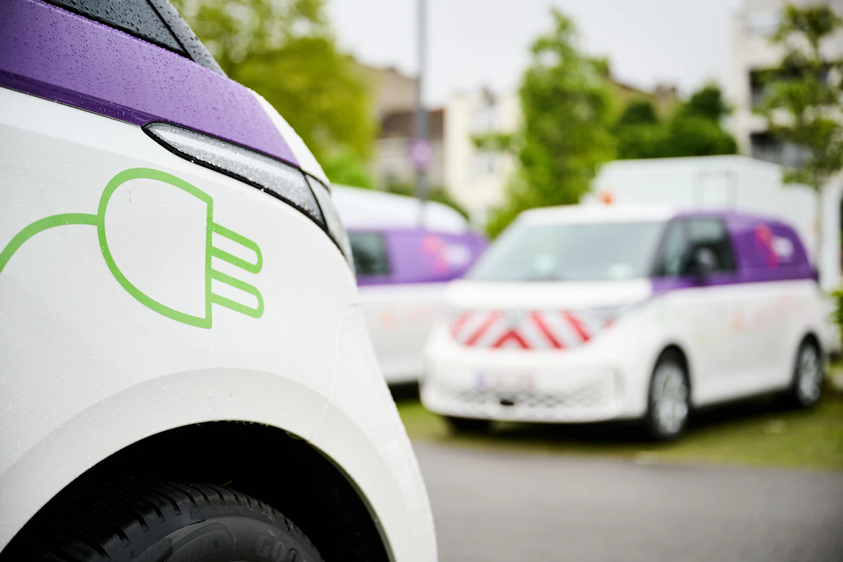 A row of parked electric Sibelga cars, including a Renault Zoe